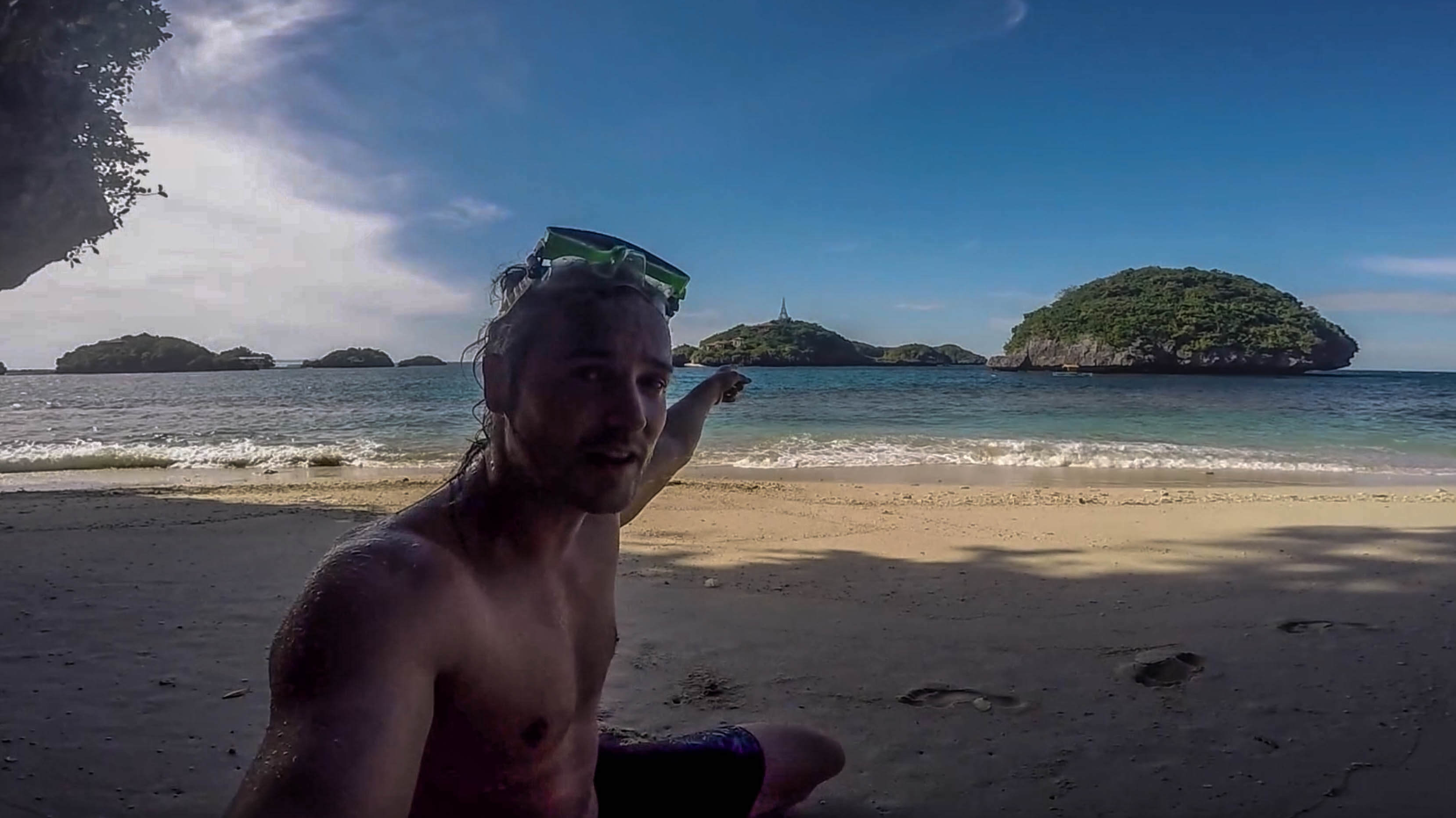 lenny through paradise chilling at little beach on old scout island in hundred islands philippines